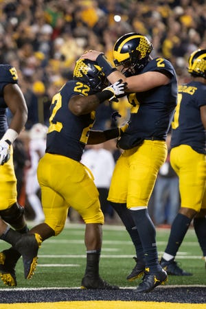 Michigan running back Karan Higdon, left, and quarterback Shea Patterson celebrate after Higdon ran for a touchdown in the second quarter.