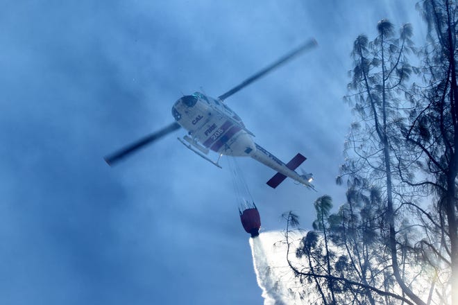 A Cal Fire helicopter drops water on the Masonic Fire as it burns vegetation along Sulphur Creek Road on Sunday morning, Oct. 14, 2018. (Hung T. Vu/Special to the Record Searchlight)