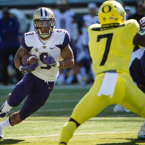 Washington running back Myles Gaskin runs with...