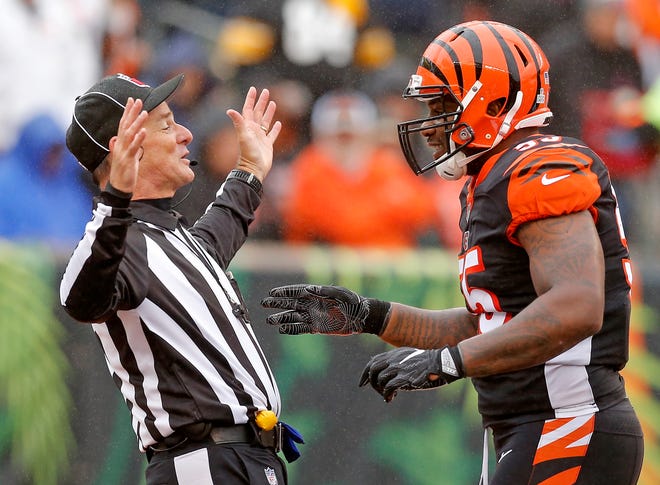 Cincinnati Bengals linebacker Vontaze Burfict (55) jokes with an official after a touchdown run by Pittsburgh Steelers running back James Conner (30) in the second quarter of the NFL Week 6 game between the Cincinnati Bengals and the Pittsburgh Steelers at Paul Brown Stadium in downtown Cincinnati on Sunday, Oct. 14, 2018. The game was tied 14-14 at half time.