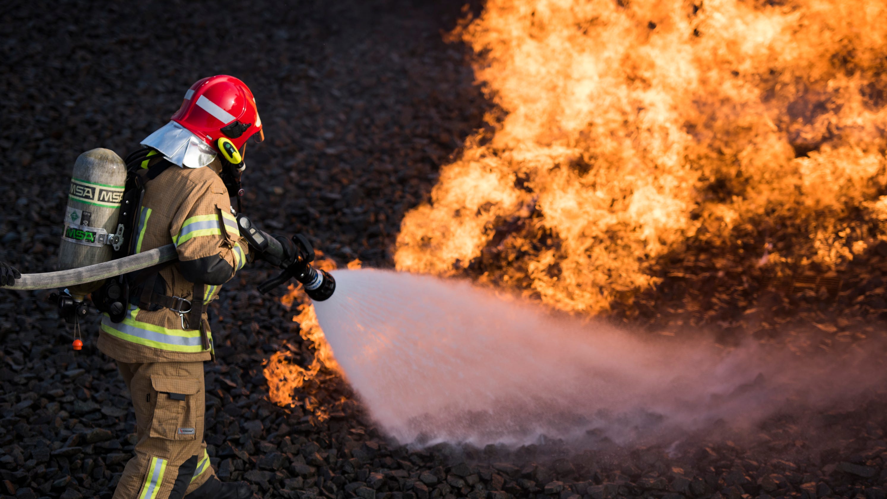 U.S. and NATO firefighters forge through the flames