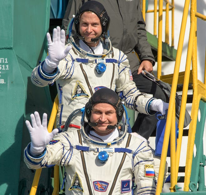 Expedition 57 Flight Engineer Nick Hague of NASA, top, and Flight Engineer Alexey Ovchinin of Roscosmos, wave farewell prior to boarding the Soyuz MS-10 spacecraft for launch, Thursday, Oct. 11, 2018 at the Baikonur Cosmodrome in Kazakhstan.