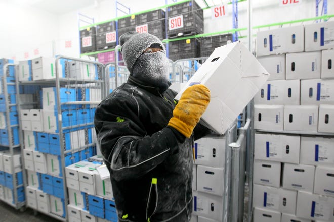 Kenny Jolliff, a freezer operator, picks orders of frozen bacteria cultures Tuesday inside a super freezer at Chr Hansen in New Berlin. Workers, dressed in double-lined suits, stay in the freezers for about two hours before taking a 20-minute break to warm up. The freezer is kept nearly 70 degrees below zero to store bacteria cultures used to make cheeses, yogurts and other dairy products, as well as wine and meat products. The company is in the process of adding 19,000 square feet of super freezer space. When finished, it will be one of the largest such freezers in the world, according to the company.