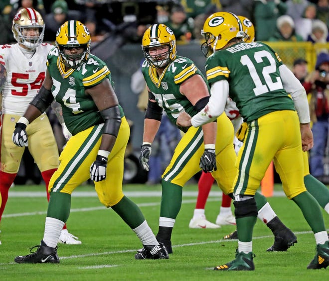 Green Bay Packers offensive tackle Byron Bell (74), offensive tackle Bryan Bulaga (75) and offensive guard Lane Taylor (65) look back at quarterback Aaron Rodgers (12) against the San Francisco 49ers at Lambeau Field Monday, October 15, 2018 in Green Bay, Wis.