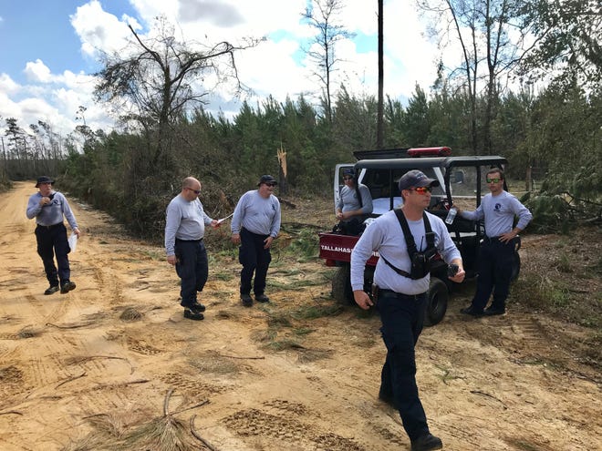 Members of Florida Urban Search and Rescue Task Force 7 fan out Tuesday in Sneads.