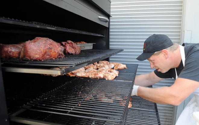 Matt Hastings, executive chef at Main Course California in Ventura, prepares racks of pork and chicken in the catering company's mobile smoker. In addition to creating a new catering menu that showcases smoked meats, Main Course California this week unveiled The Smokehouse, a pop-up restaurant with grab-and-go sandwiches and more for weekday lunch service. The company will also participate in the Star's Wine & Food Experience Nov. 10 in Camarillo.