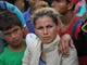 ESQUIPULAS, GUATEMALA - OCTOBER 15:  A caravan of more than 1,500 Honduran migrants pauses at a Guatemalan police checkpoint after crossing the border from Honduras on October 15, 2018 in Esquipulas, Guatemala. The caravan, the second of 2018, began Friday in San Pedro Sula, Honduras with plans to march north through Guatemala and Mexico en route to the United States. Honduras has some of the highest crime and poverty rates in Latin America.  (Photo by John Moore/Getty Images) ORG XMIT: 775243532 ORIG FILE ID: 1052219302