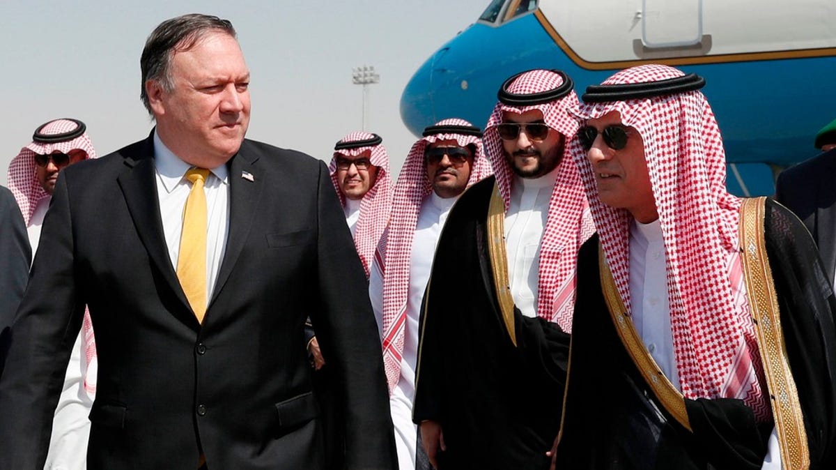 Secretary of State Mike Pompeo, left, walks alongside Saudi Foreign Minister Adel al-Jubeir after arriving in Riyadh, on October 16, 2018.