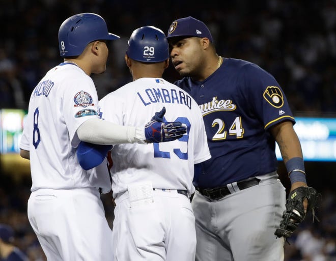 Brewers first baseman Jesus Aguilar has something to say to Manny Machado after the Dodgers shortstop clipped his heel on a groundout in the 10th inning of Game 4 on Tuesday.
