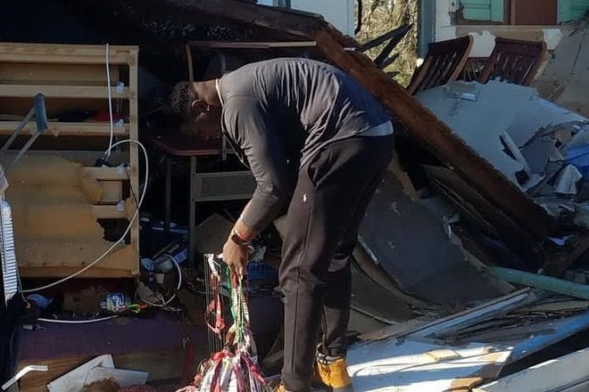 FSU defensive end Janarius Robinson examining the remains of his Panama City house in the wake of Hurricane Michael.