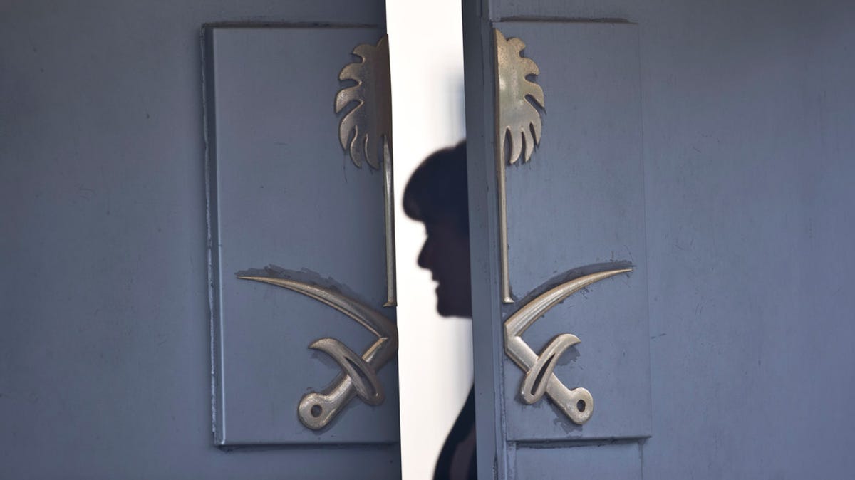 A consulate staff member is seen behind the entrance of Saudi Arabia's diplomatic compound in Istanbul, on Oct. 17, 2018.