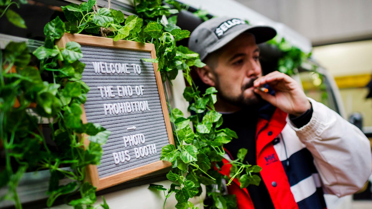 Matthew Macdougall smokes a joint during a "Wake and Bake" legalized marijuana event in Toronto on Wednesday, Oct. 17, 2018. Canada became the largest country with a legal national marijuana marketplace as sales began early Wednesday in Newfoundland. (Christopher Katsarov/The Canadian Press via AP) ORG XMIT: CKL102