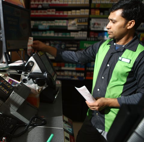 A worker processes lottery tickets on October 16,...