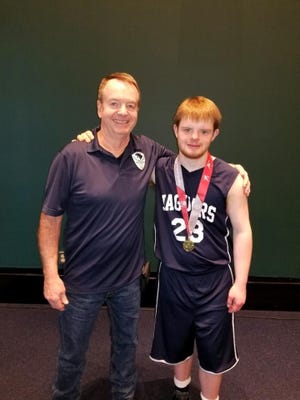 John Brembt with his son, Zachary, who won a gold medal in basketball earlier this year. Brembt began volunteering his time to coach with Hunterdon County Special Olympics last year. The program has about 500 athletes.
