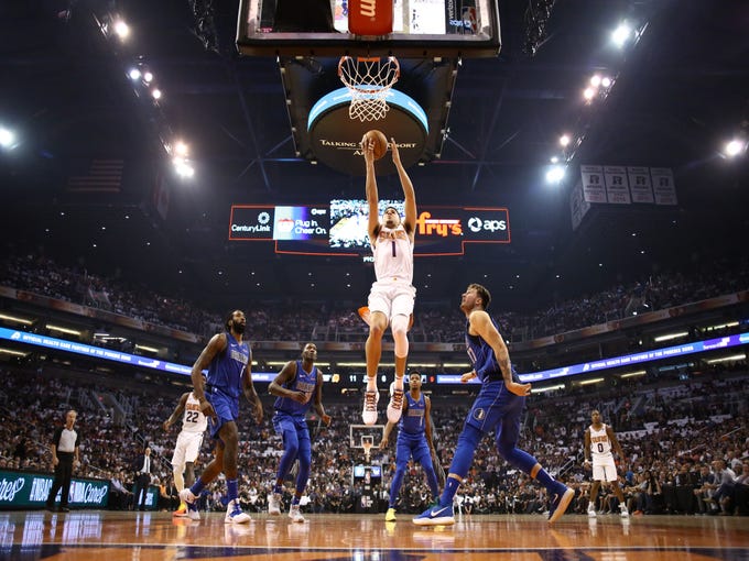 Phoenix Suns guard Devin Booker drives and scores against the Dallas Mavericks during the season opener at Talking Stick Resort Arena on Oct. 17, 2018, in Phoenix, Ariz.