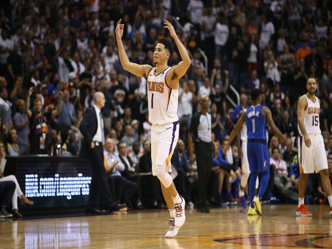Phoenix Suns Devin Booker reacts after being fouled on a 3-point shot against the Dallas Mavericks during the season opener at Talking Stick Resort Arena on Oct. 17, 2018, in Phoenix, Ariz.
