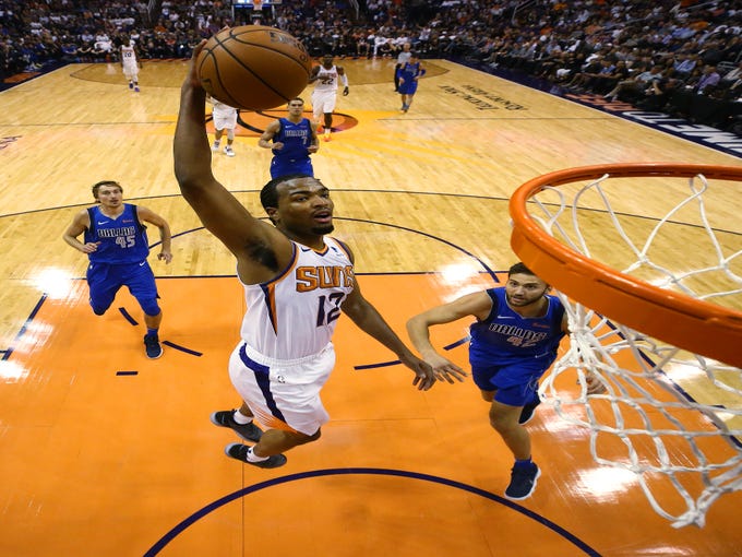Phoenix Suns TJ Warren slam-dunks the ball against the Dallas Mavericks during the season opener at Talking Stick Resort Arena on Oct. 17, 2018, in Phoenix, Ariz.