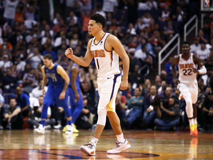 Phoenix Suns Devin Booker pumps his fist during their win over the Dallas Mavericks during the season opener at Talking Stick Resort Arena on Oct. 17, 2018, in Phoenix, Ariz.