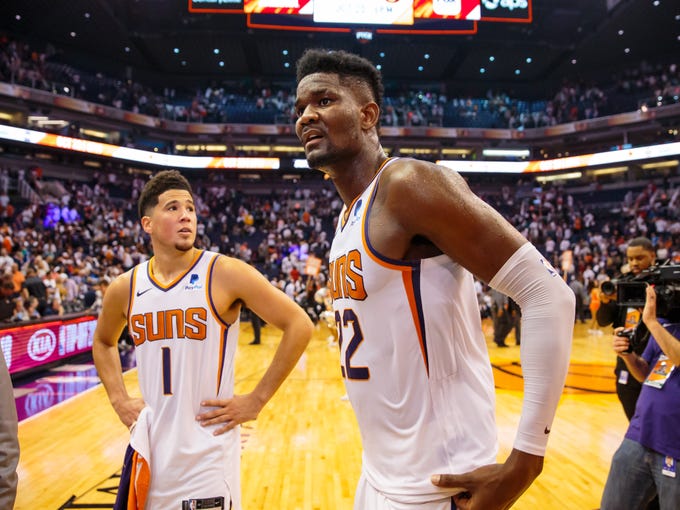 Oct 17, 2018; Phoenix, AZ, USA; Phoenix Suns center Deandre Ayton (22) and guard Devin Booker (1) following the game against the Dallas Mavericks at Talking Stick Resort Arena. Mandatory Credit: Mark J. Rebilas-USA TODAY Sports