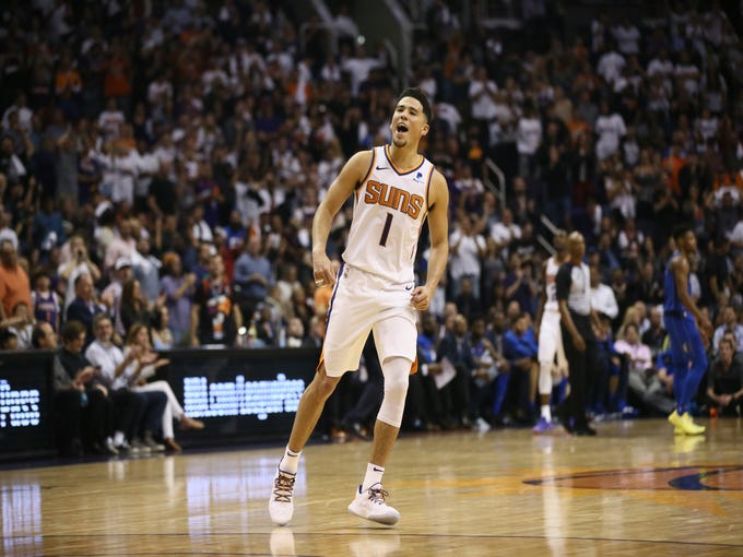 Phoenix Suns Devin Booker reacts after being fouled on a 3-point shot against the Dallas Mavericks during the season opener at Talking Stick Resort Arena on Oct. 17, 2018, in Phoenix, Ariz.