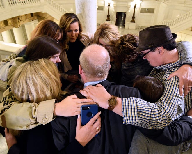 Survivors of child sexual abuse hug in the Pennsylvania Capitol in Harrisburg while awaiting legislation to respond to a landmark state grand jury report on child sexual abuse in the Roman Catholic Church on Wednesday, Oct. 17, 2018.