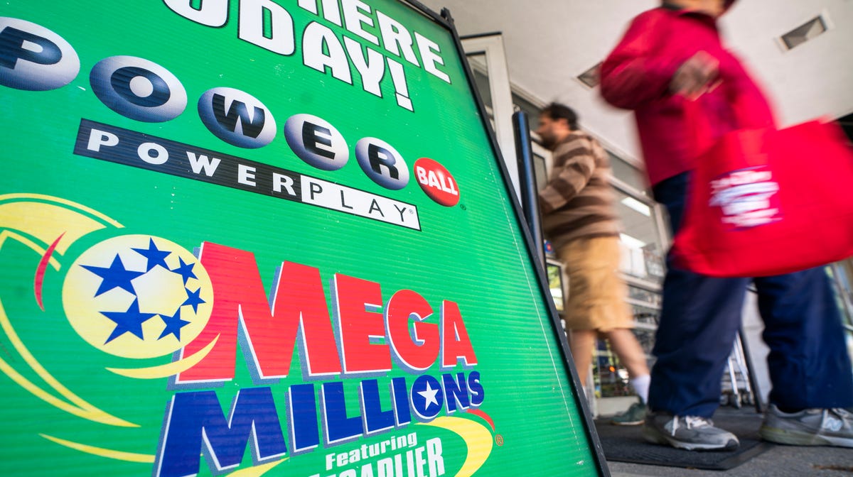 An advertisement for Mega Millions, a 44-state lottery with a jackpot of nearly one billion US dollars, outside a grocery store in Washington, Oct. 18,  2018. Friday's Mega Millions drawing will be the second largest lottery jackpot in US history.