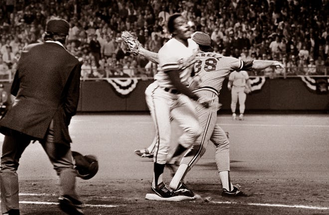 Umpire Don Denkinger looks on as Cardinals pitcher Todd Worrell stretches out to catch the ball as Royals batter Jorge Orta steps on the base during the ninth inning in Game 6 of the 1985 World Series.