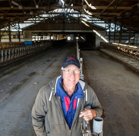 Eric Lyon stands in his family's empty dairy cow...
