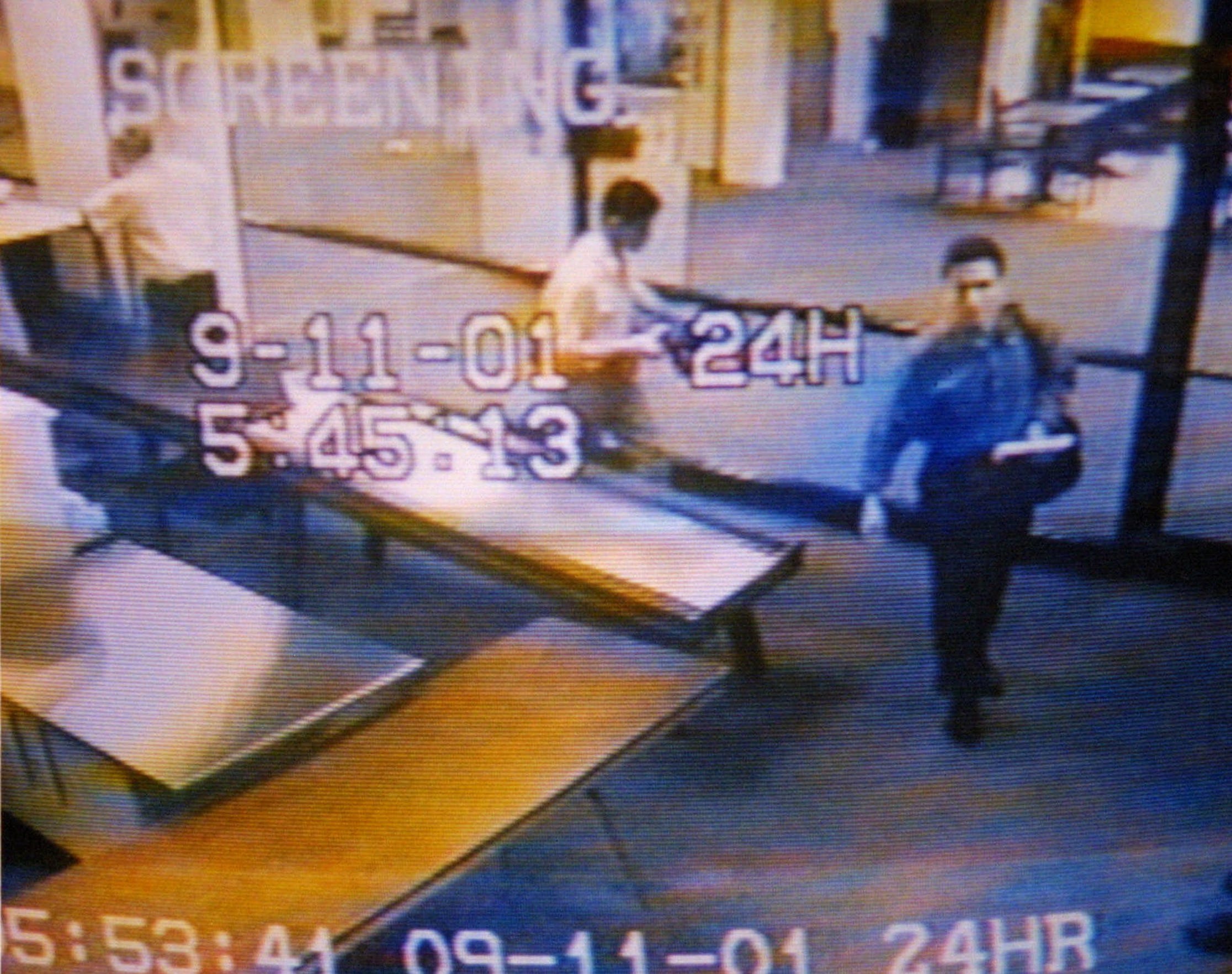 Two men, identified by authorities as suspected hijackers Mohamed Atta, right, and Abdulaziz Alomari, center, pass through airport security, Tuesday, Sept. 11, 2001 at Portland International Jetport in this photo from the airport surveillance tape released Wednesday, Sept. 19, 2001. Authorities say the two men took a commuter flight to Boston before boarding American Airlines Flight 11 which was one of four jetliners hijacked Sept. 11, 2001, and one of two which were crashed into the World Trade Center.