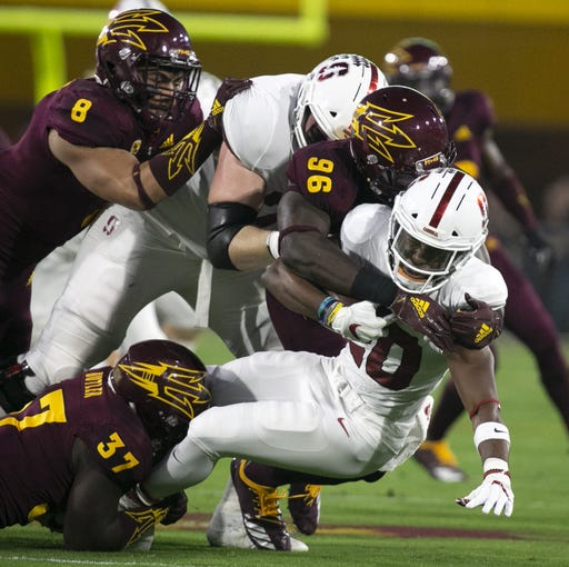 ASU defensive lineman Jalen Bates tackles Stanford running back Bryce Love during the first quarter of the Pac-12 college football game at Sun Devil Stadium in Tempe on October 18, 2018.