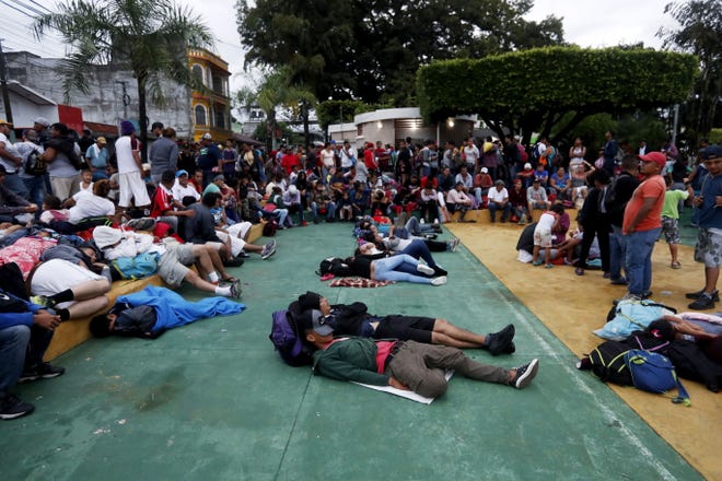 epa07104769 Honduran migrants rest in the Tecun Uman's park in Escuintla, Guatemala, 19 October 2018, before continue their way to Mexico. Migrants, who hope to arrive to the United States to seek better living conditions, slept in an open-air theater and in the Catholic church of Tecun Uman, a few kilometers from the Suchiate River, which divides Guatemala and Mexico, where a group of migrants has already started a new stage of the crossing.  EPA-EFE/ESTEBAN BIBA ORG XMIT: GU502