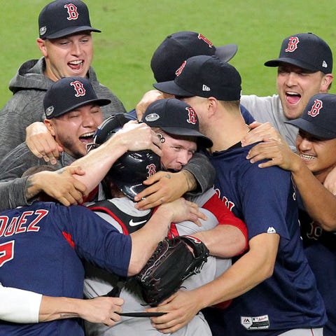 Red Sox players celebrate on the field in Houston...