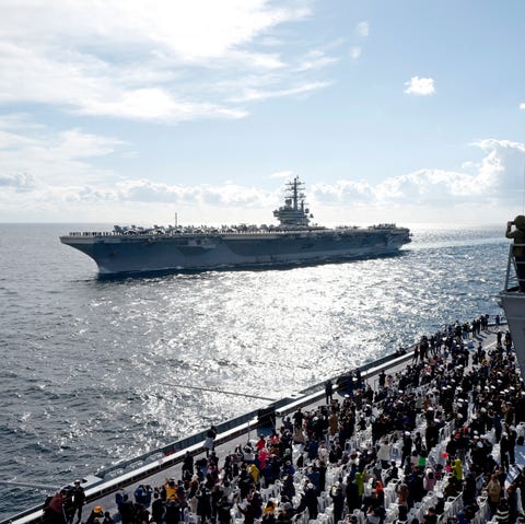 Spectators watch the US Navy's Nimitz-class...