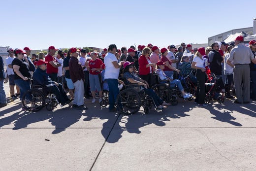 Supporters of President Donald Trump stand in a long line to watch the president's speech supporting Martha McSally at Phoenix-Mesa Gateway Airport on Oct. 19, 2018.