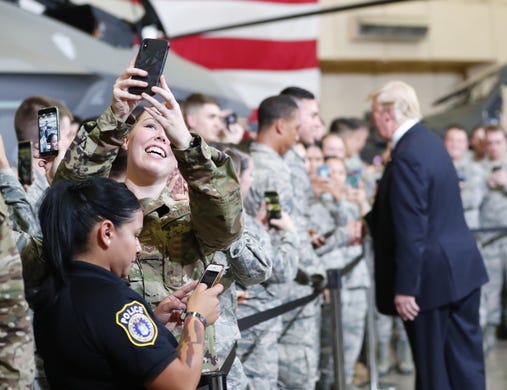 An airman takes a selfie as President Donald Trump shakes hands during a defense capability tour at Luke Air Force Base in Glendale, on Oct. 19, 2018.