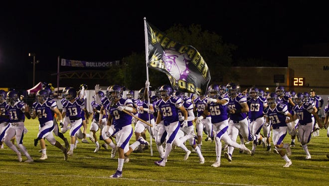 Queen Creek players run out onto the field before their game with Highland Friday, Oct. 19, 2018. #azhsfb