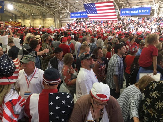 Trump supporters wait to see the president at Phoenix-Mesa Gateway Airport on Oct. 19, 2018.