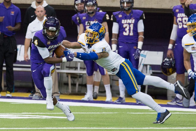 UNI's Deion McShane runs the ball as South Dakota State's Makiah Slade just misses the tackle letting McShane run the ball in for a touchdown during Saturday evening's game.
