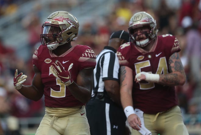 Florida State running back Cam Akers celebrates a touchdown in front of lineman Alec Eberle during a game against Wake Forest at Doak Campbell Stadium on Saturday, Oct. 20, 2018.