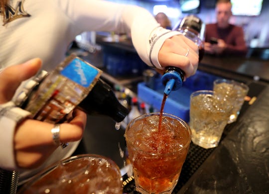 A bartender at Buzz's Pub & Grill pours a few old fashioneds using Gary's Old Fashioned Mix Thursday, Oct. 4, 2018, in Freedom, Wis.
Danny Damiani/USA TODAY NETWORK-Wisconsin