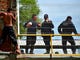 A Honduran migrant heading in a caravan to the US, prepares to jump to the Suchiate River from the Guatemala-Mexico international border bridge, near Mexican Federal Police officers, in Ciudad Hidalgo, Chiapas state, Mexico, on Oct. 20, 2018.