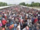 Thousands of Honduran migrants wait for access on the bridge that crosses the Suchiate River after crossing the fence on the border with Guatemala to enter in Ciudad Hidalgo, Mexico on Oct. 19, 2018. 