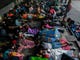Honduran migrants taking part in a caravan heading to the US, sleep in the main square of Ciudad Tecun Uman, Guatemala, in the border with Mexico, on Oct. 20, 2018. Thousands of migrants who forced their way through Guatemala's northwestern border and flooded onto a bridge leading to Mexico, where riot police battled them back, on Saturday waited at the border in the hope of continuing their journey to the United States. 