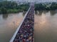 Aerial view of a Honduran migrant caravan heading to the US, on the Guatemala-Mexico international border bridge in Ciudad Hidalgo, Chiapas state, Mexico, on Oct. 20, 2018. 