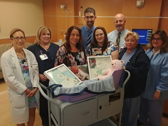 Left to Right: Dr. Sara Garmel, Darlene Baczynski, Angie Winton, Scott Duley and Alison Duley, and Dearborn Hospital Staff in July of 2018 after the Duley's son William died after his birth. Metro Detroit Share donated their first temperature-controlled 