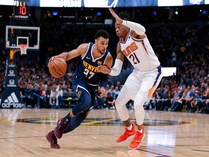 Oct 20, 2018; Denver, CO, USA; Phoenix Suns forward Richaun Holmes (21) guards Denver Nuggets guard Jamal Murray (27) in the second quarter at the Pepsi Center. Mandatory Credit: Isaiah J. Downing-USA TODAY Sports