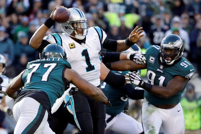 Carolina Panthers quarterback Cam Newton (1) throws a pass with Philadelphia Eagles defensive end Michael Bennett (77) and defensive tackle Fletcher Cox (91) adding pressure during the second half of an NFL football game, Sunday, Oct. 21, 2018, in Philadelphia. (AP Photo/Matt Rourke)