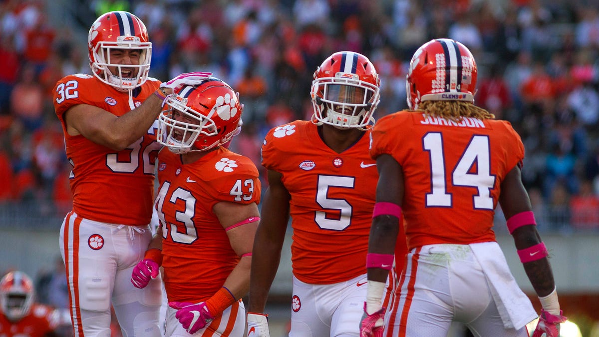 Safety Kyle Cote (32), linebacker Chad Smith (43), linebacker Shaq Smith (5), and safety Denzel Johnson (14) celebrate during another win for unbeaten Clemson.
