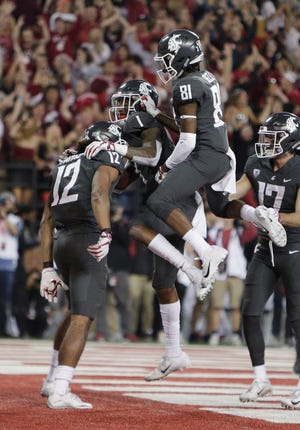 Washington State wide receiver Dezmon Patmon (12) celebrates his touchdown catch with wide receiver Davontavean Martin (1) and wide receiver Renard Bell (81) during Saturday's win over Oregon.