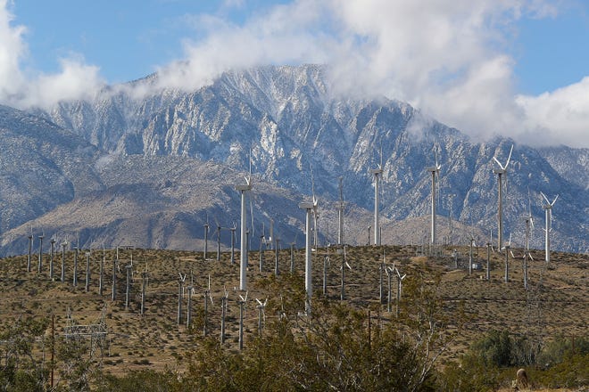 Older and newer wind turbines produce energy on a windy day in February 2018. In the background is Mt. San Jacinto.